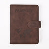 A dark brown leather passport holder with the word PASSPORT and a world map design on the cover.