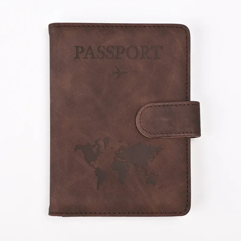 A dark brown leather passport holder with the word PASSPORT and a world map design on the cover.