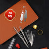 A collection of 34 sewing needles, including large-eye and machine needles, displayed on a brown surface.