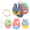 A set of silicone fruit teethers and rattles in various colors including green, pink, yellow, and blue.
