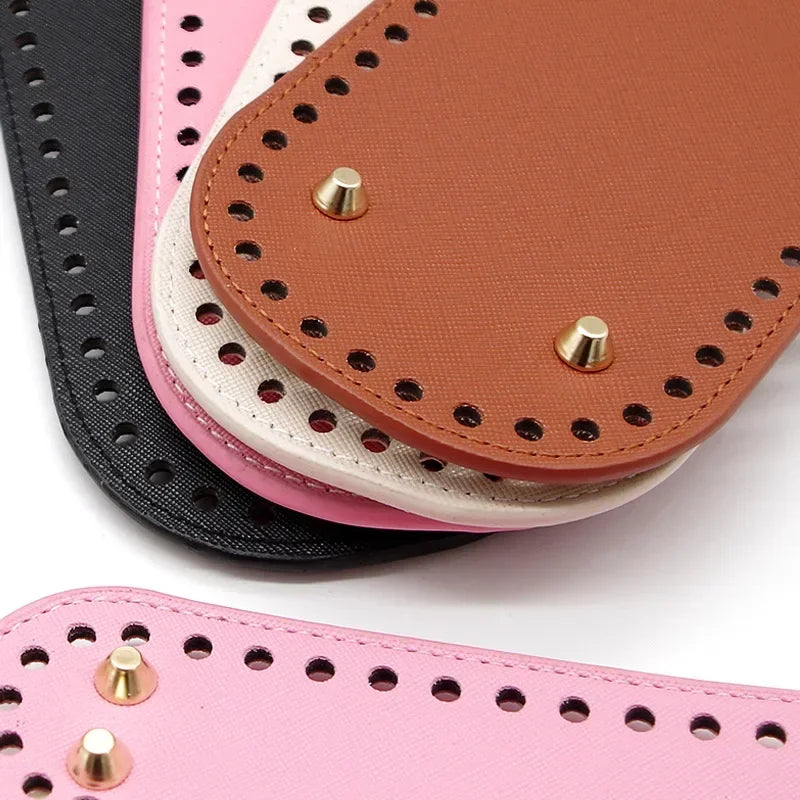 A stack of pink, beige, and black PU leather oval bags with gold studs.