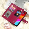 A magenta crossbody phone wallet with card slots and zipper closure resting on a white silk fabric next to a smartphone and p