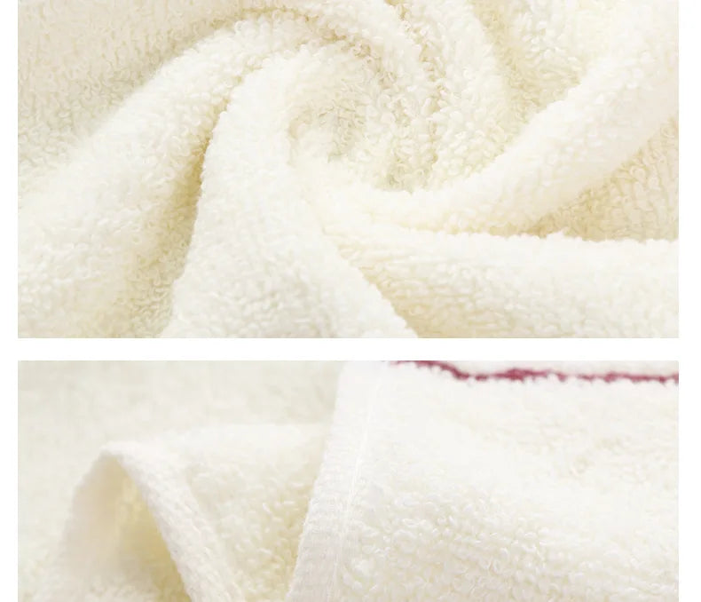 A close-up of a white, fluffy bath towel set being rolled or draped.
