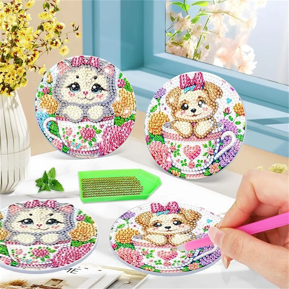 A set of diamond painting coasters featuring cute animal designs like a bear and a kitten, displayed on a white surface.