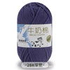 A skein of purple milk cotton blend yarn with a label featuring a cow and Chinese text.