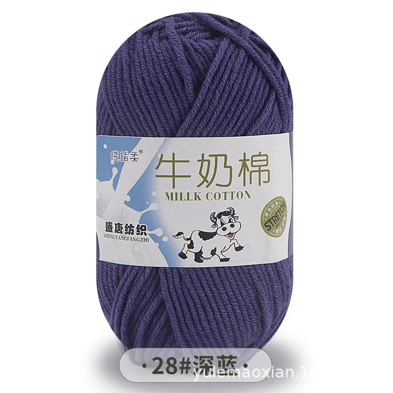 A skein of purple milk cotton blend yarn with a label featuring a cow and Chinese text.
