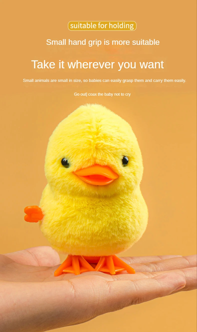 A yellow wind-up walking chicken toy is held in an open palm.