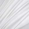 Flowing white fabric folds creating soft, luxurious drapery texture.