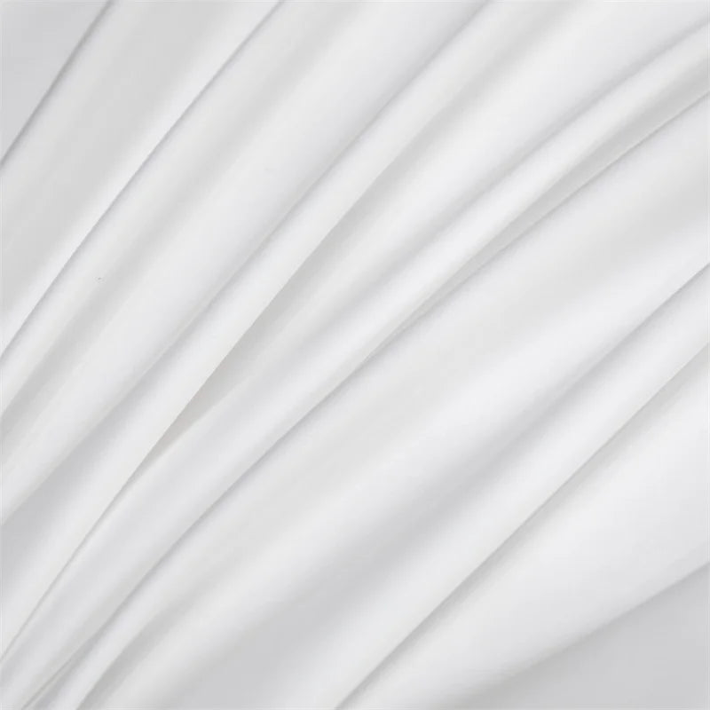 Flowing white fabric folds creating soft, luxurious drapery texture.