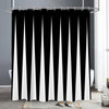 Black and white abstract geometric shower curtain hanging on a rod in a bathroom setting