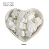 A small white bowl filled with silicone crown star heart beads for DIY jewelry making