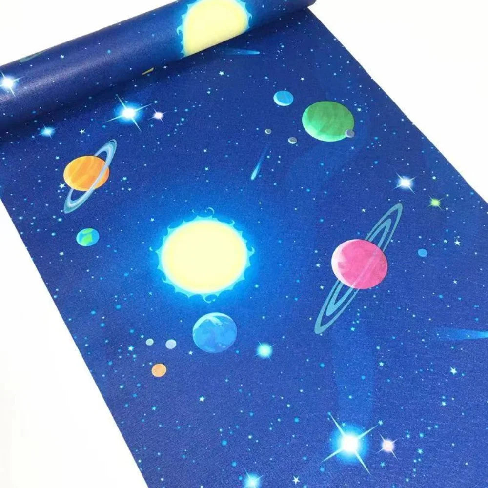Blue peel-and-stick wallpaper featuring a starry night sky with colorful planets and stars