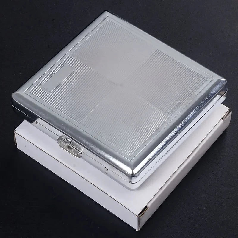 A silver stainless steel cigarette case with an embossed pattern, shown open on a dark surface.