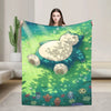 A person holds up a green and blue Snorlax themed plush throw blanket in a bright indoor setting.