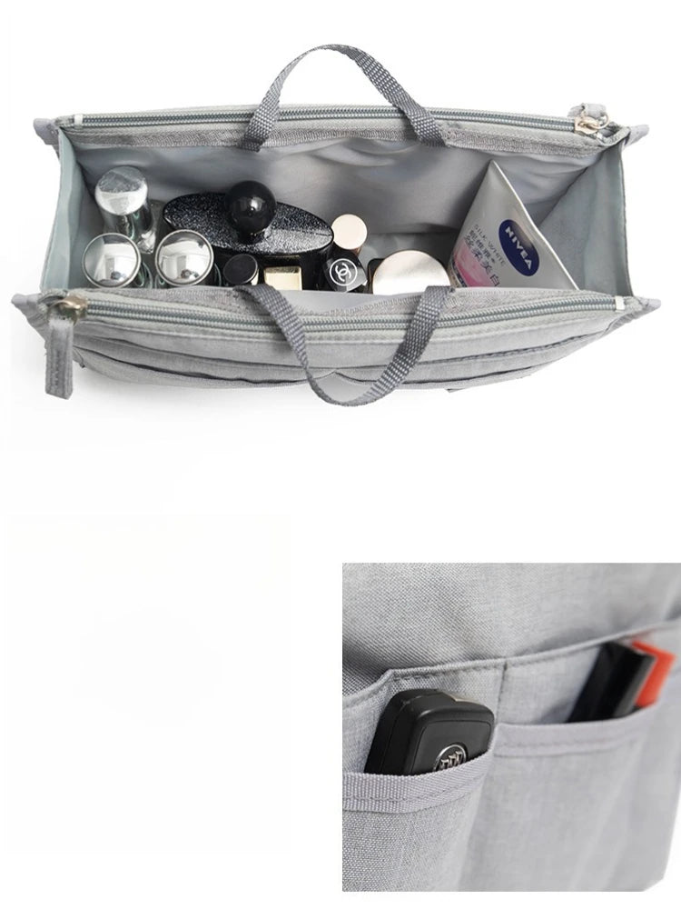 A gray purse organizer insert with multiple compartments holding various small items like makeup and accessories.