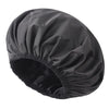 A black satin-lined waterproof shower cap for hair protection shown from above.