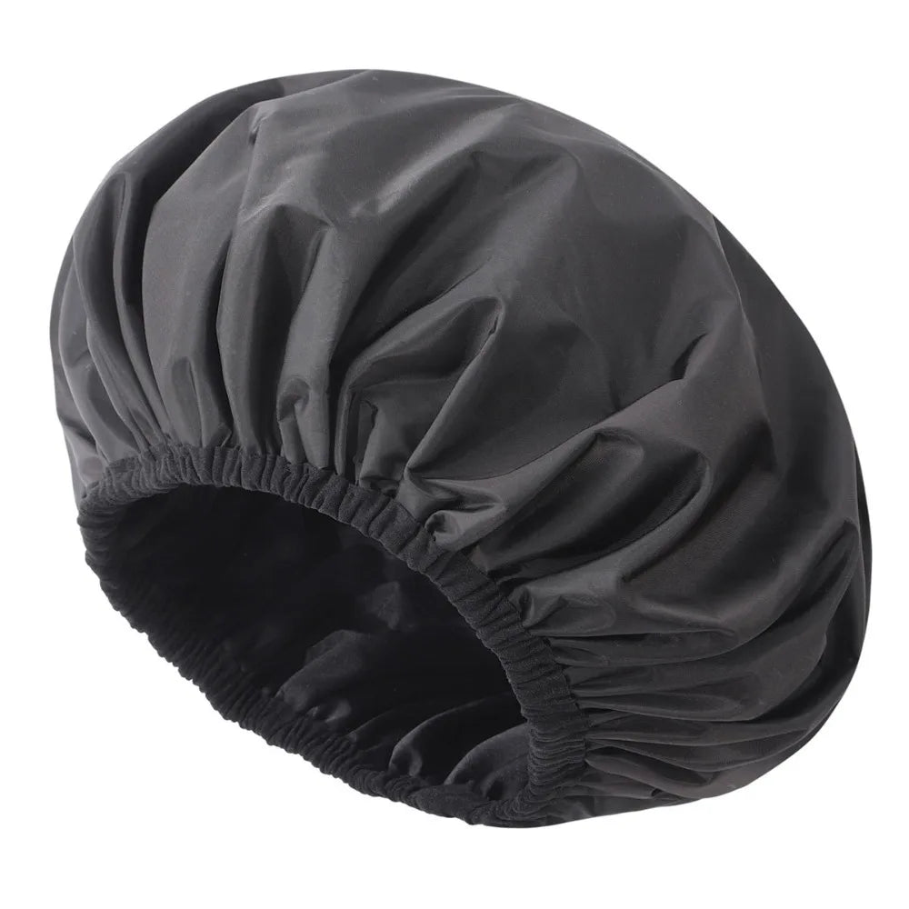 A black satin-lined waterproof shower cap for hair protection shown from above.