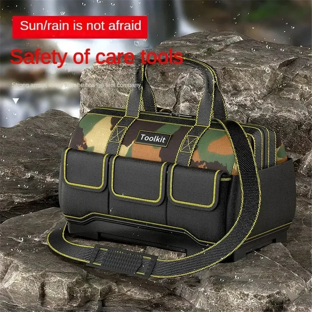 A black camouflage tool kit bag with yellow trim is shown resting on a dark rock surface.