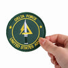 A round olive green embroidered patch for Delta Force featuring a yellow lightning bolt design.