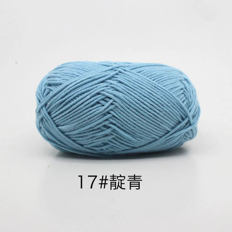 A ball of soft light blue 4-ply milk cotton yarn for knitting and crochet.
