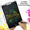 A hand holds a 12-inch black LCD writing tablet displaying a green drawing of Santa Claus and presents.