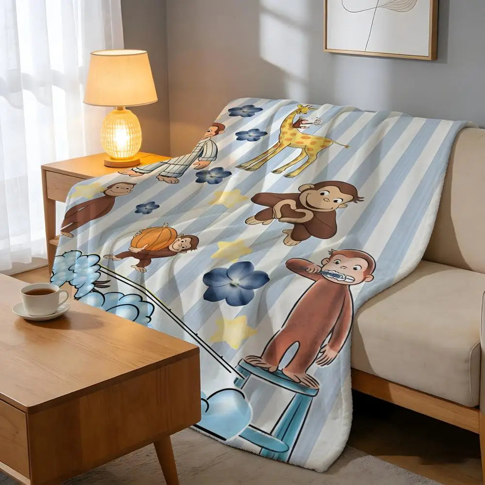 A light blue and white patterned plush throw blanket featuring cartoon animals like a giraffe, bear, and monkey.
