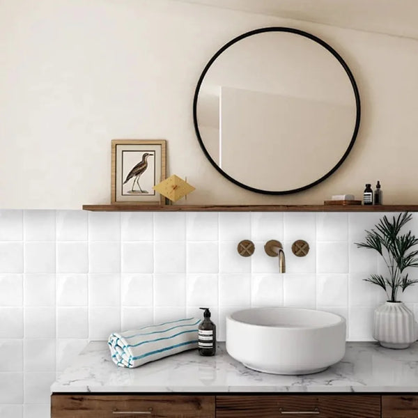 A bathroom vanity featuring a white vessel sink and marble countertop with a tile backsplash.