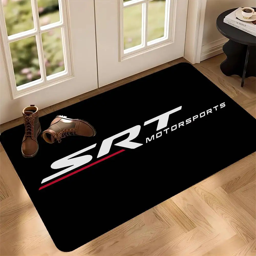 Black doormat featuring white text SRT MOTORSPORTS and a red line on a wooden floor.