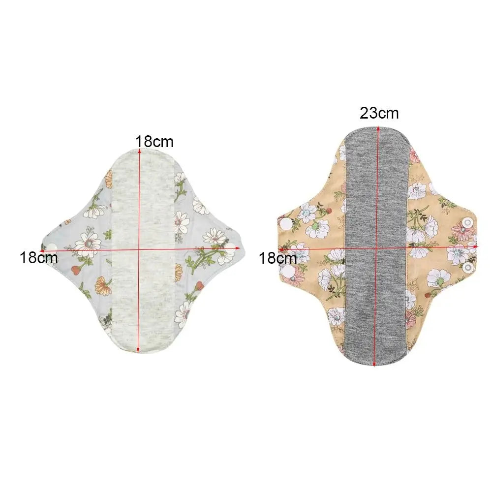 Reusable cotton menstrual pads shown from the top and side, measuring 18cm by 23cm.