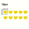 A set of 10 yellow heart stickers for night safety and car decoration.