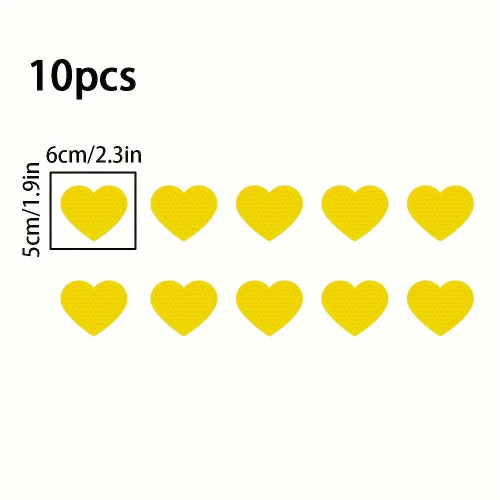 A set of 10 yellow heart stickers for night safety and car decoration.