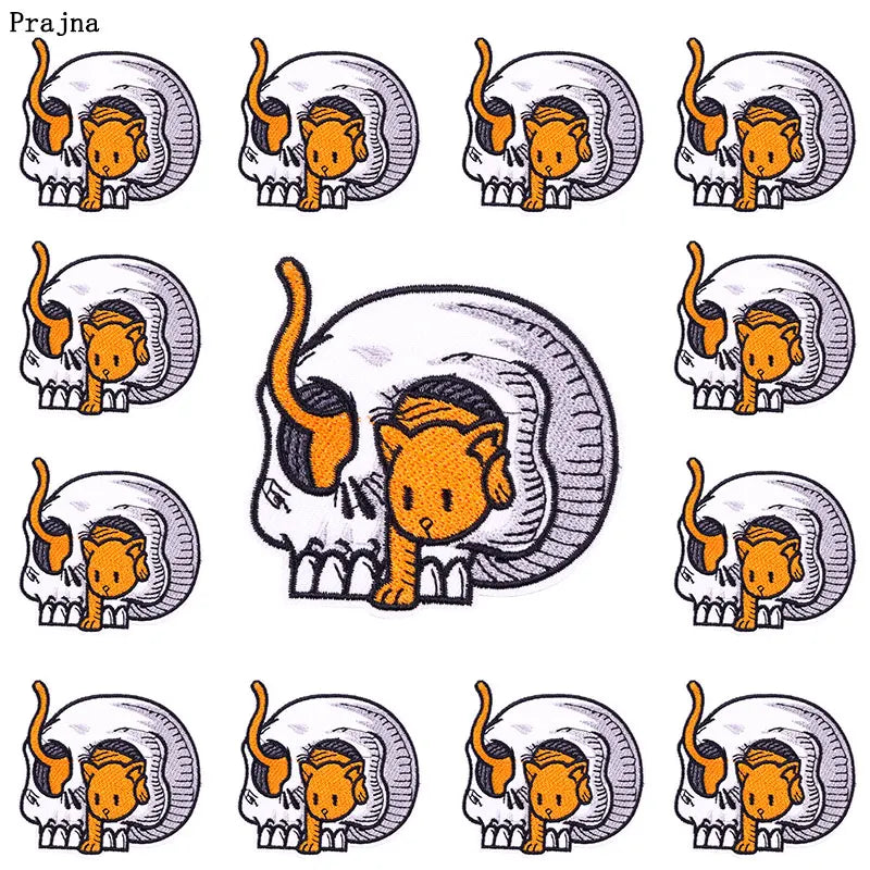 A set of ten embroidered iron-on patches depicting stylized cat skulls with orange and black details.