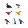A collection of realistic animal figurines including a black bird, a brown bird, a red bird, and blue birds.
