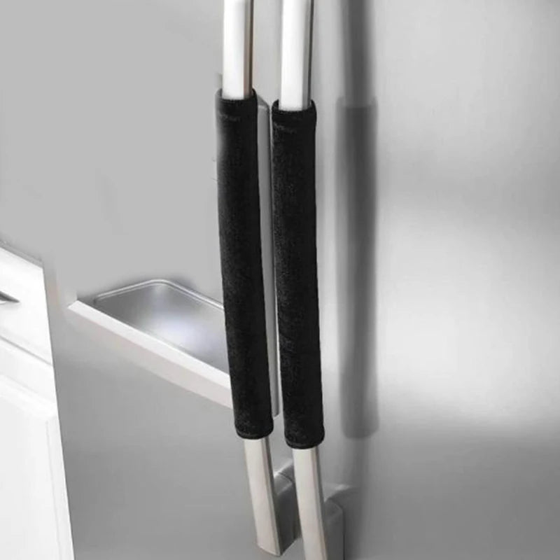 A close-up of two black velvet anti-skid protector covers for refrigerator handles.