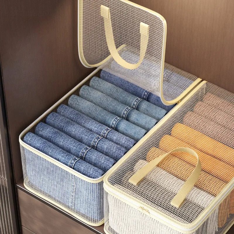 Clear mesh storage bags for clothes blankets and bedding stacked in a wooden drawer.
