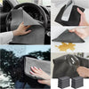 Reusable gray microfiber glass cleaning cloths being used to wipe a window and a car interior.