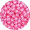 A close-up view of small, round pink imitation pearl beads for jewelry making.