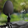 A close-up view of a black 360° adjustable bicycle rearview mirror mounted on a bike handlebar.