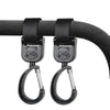 Black rotating hooks designed for hanging bags and essentials on a stroller bar.