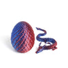 A set of 3D printed dragon egg and dragon figurine, featuring a textured red and blue appearance.