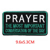 Black embroidered iron-on letter patch with teal stitching featuring the text PRAYER THE MOST IMPORTANT CONVERSATION OF THE D