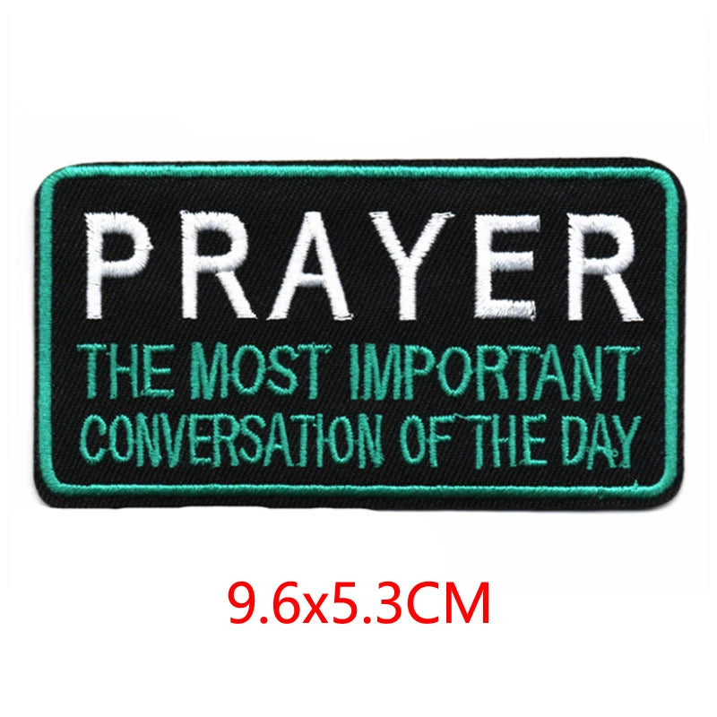 Black embroidered iron-on letter patch with teal stitching featuring the text PRAYER THE MOST IMPORTANT CONVERSATION OF THE D