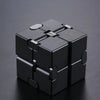 A black metal infinity fidget cube with interlocking pieces, shown from above.