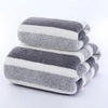 A stack of gray and white striped microfiber towels folded neatly.