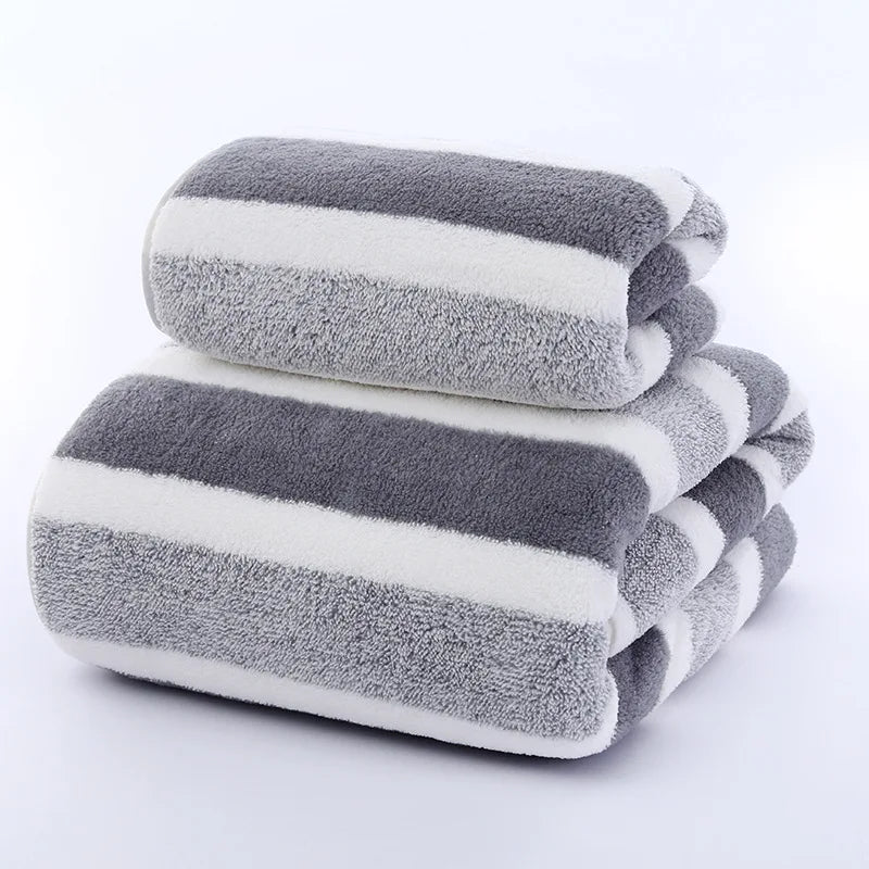A stack of gray and white striped microfiber towels folded neatly.