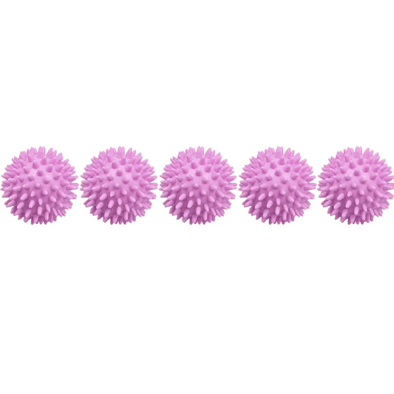A row of pink reusable laundry balls for tangle-free washing and softening.