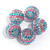 A set of five resin rhinestone beads with a two-tone pink and blue striped design.