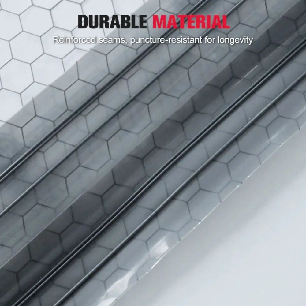Close-up of a silver vacuum compression bag with hexagonal texture and reinforced seams.