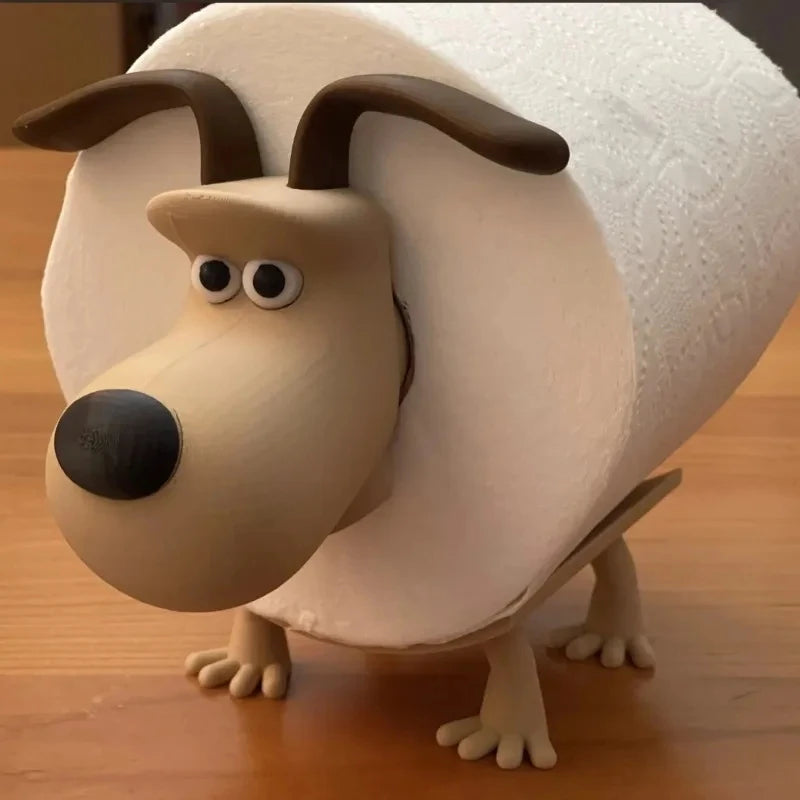 A beige animal-shaped toilet paper holder with large ears and a snout sits on a wooden surface.