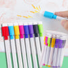An assortment of eight fine tip whiteboard markers in various colors are shown being used on a white surface.